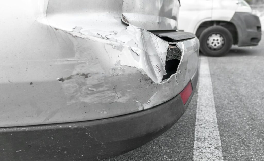 Back of gray car get damaged from accident on the road